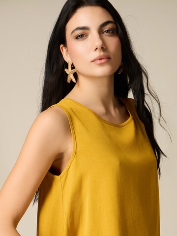 Haut oltre en jaune