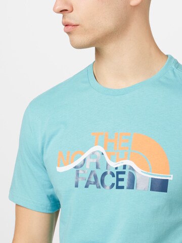 mėlyna THE NORTH FACE Marškinėliai 'MOUNTAIN'