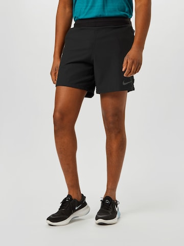 NIKE Regular Sports trousers in Black: front