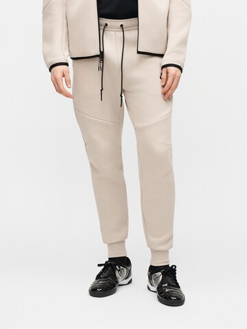 Nike Sportswear Zwężany krój Spodnie 'Tech Fleece' w kolorze beżowy: przód