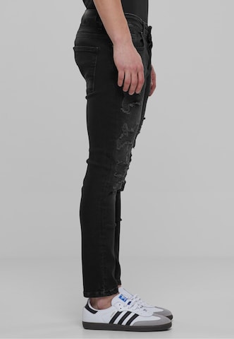 Skinny Jeans di Karl Kani in nero