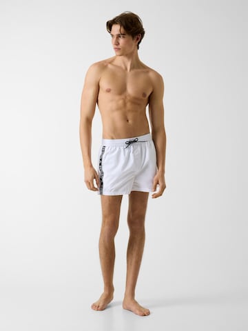 GUESS Board Shorts in White: front