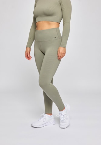 SNOCKS Skinny Workout Pants in Green: front