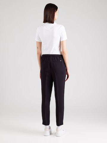 Slimfit Pantaloni con piega frontale di TOMMY HILFIGER in nero