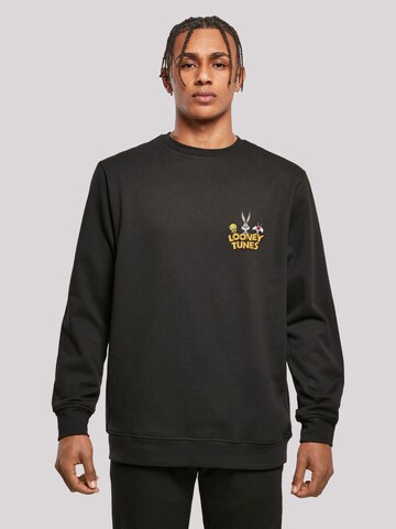 F4NT4STIC Sweatshirt 'Looney Tunes Group Faux Pocket' in Zwart: voorkant