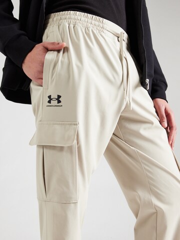 UNDER ARMOUR Tapered Sports trousers 'Vibe' in Beige