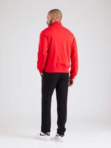 Tuta da jogging di Champion Authentic Athletic Apparel in rosso