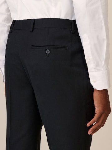 Skinny Pantaloni con piega frontale di Next in nero