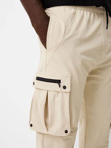 Bershka Tapered Cargobyxa i beige
