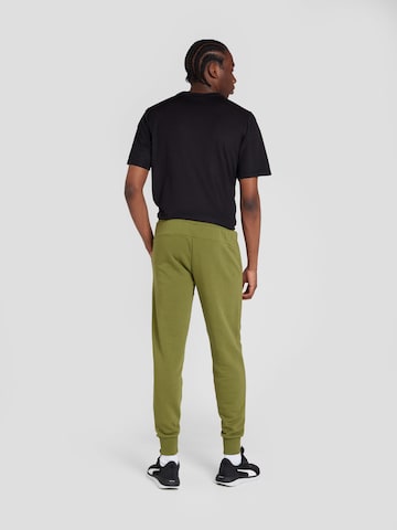 PUMA Tapered Sports trousers 'ESS+' in Green