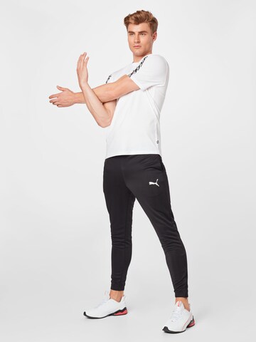 PUMA Tapered Sportbroek 'TeamRise' in Zwart