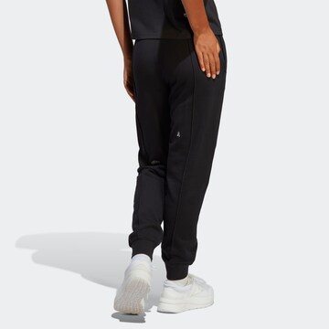 ADIDAS SPORTSWEAR Tapered Sports trousers 'Healing Crystals Inspired Graphics' in Black