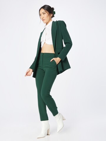 Slimfit Pantaloni con piega frontale di Warehouse in verde
