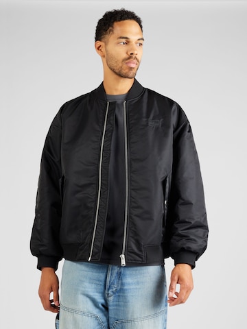 Veste mi-saison Tommy Jeans en noir : devant