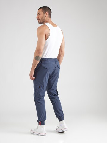 mėlyna ALPHA INDUSTRIES Siaurėjantis Laisvo stiliaus kelnės