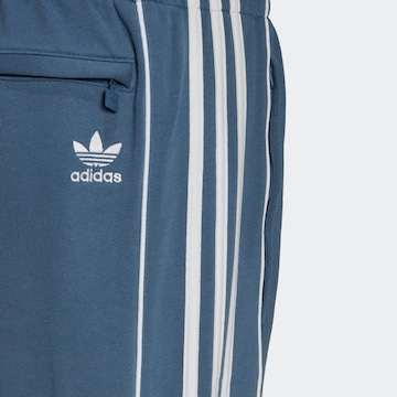 ADIDAS ORIGINALS Zúžený Kalhoty 'Rekive' – modrá