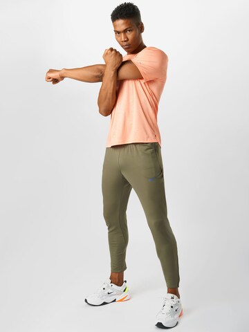 NIKE Slim fit Workout Pants in Green