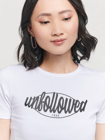 UNFOLLOWED x ABOUT YOU - Camiseta 'GIRLFRIEND' en blanco