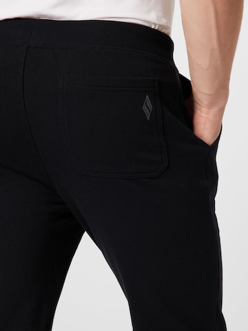 SKECHERS Tapered Sports trousers in Black