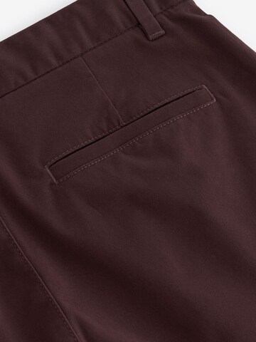 Next Slimfit Chinohousut värissä punainen