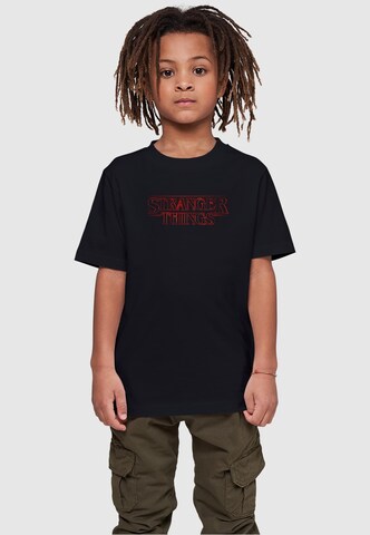 ABSOLUTE CULT Shirt 'Stranger Things - Glow' in Zwart: voorkant