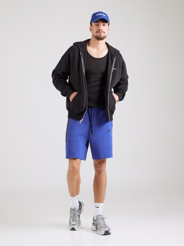 Nike Sportswear Loosefit Bukser 'Tech Fleece' i blå