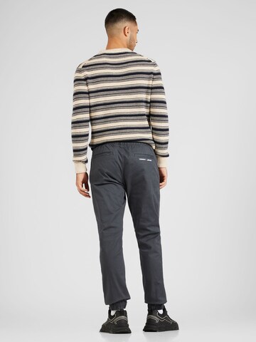 Tommy Jeans Tapered Trousers 'SCANTON' in Grey