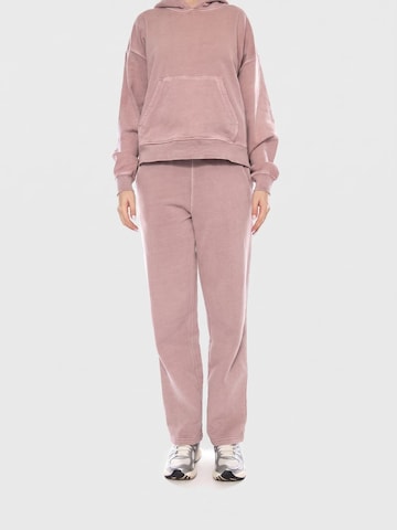 Carhartt WIP Luźne Spodnie 'W Benton Sweat Pant' w kolorze różowy