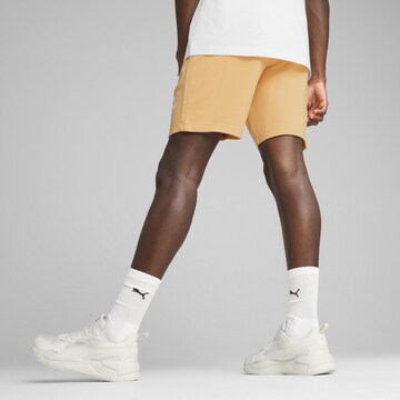 PUMA Regular Broek 'Class' in Oranje