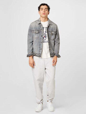 Tapered Pantaloni 'Badge' di Tommy Jeans in grigio