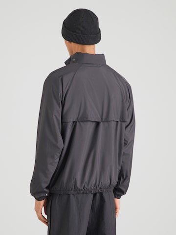 Nike Sportswear Átmeneti dzseki 'WR' - fekete