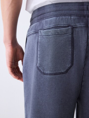 pilka Next Plačios klešnės Kelnės