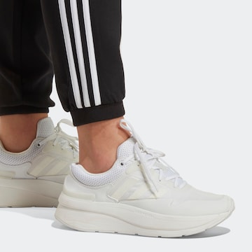 ADIDAS SPORTSWEAR Tapered Παντελόνι φόρμας σε μαύρο