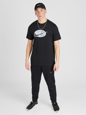 Nike Sportswear T-shirt 'SWOOSH' i svart