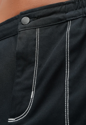 Largi Pantaloni 'STREET' de la Nike Sportswear pe negru