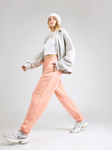 Tapered Pantaloni 'PHNX FLC' de la Nike Sportswear pe portocaliu