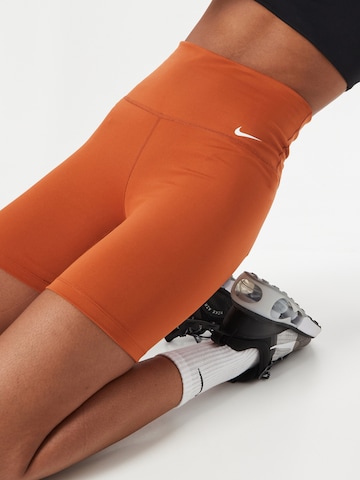 NIKE Skinny Sportbroek 'ONE' in Oranje