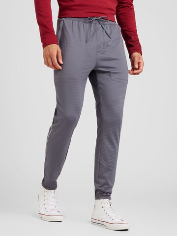 UNDER ARMOUR - Tapered Calças de desporto 'Vanish CW' em cinzento: frente