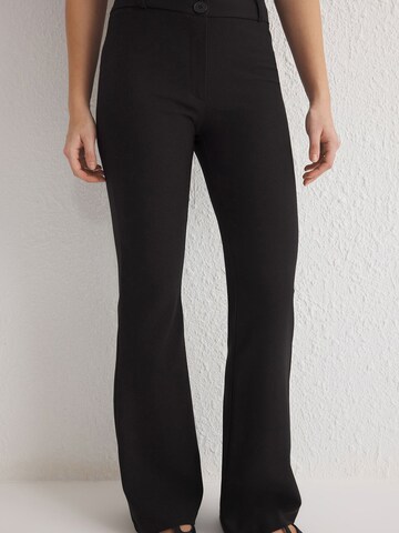 Trendyol Flared Trousers in Black: front