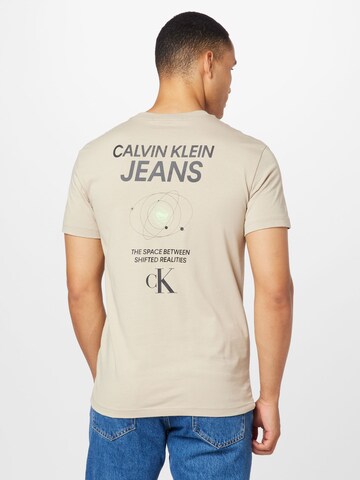 Tricou 'Future Galaxy' de la Calvin Klein Jeans pe bej: față