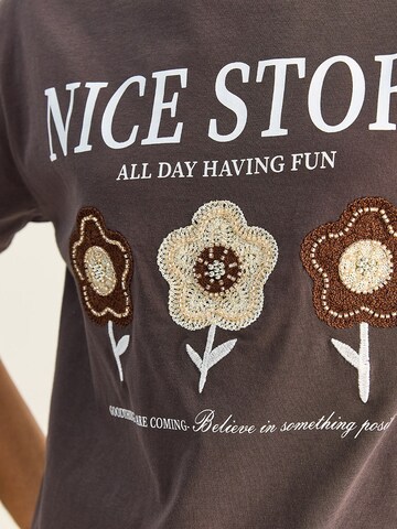 T-shirt 'T-Shirts' Bianco Lucci en marron