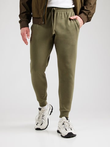 UNDER ARMOUR Tapered Sporthose in Grün: Vorderseite