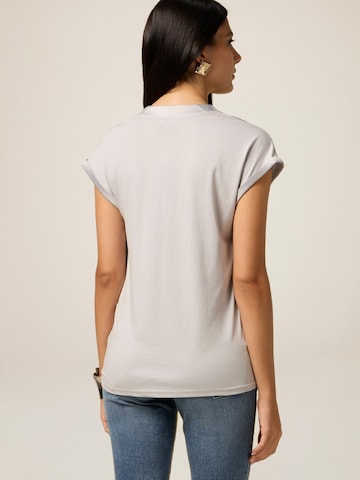 Top di oltre in grigio