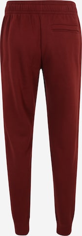 Effilé Pantalon de sport 'Rival' UNDER ARMOUR en rouge