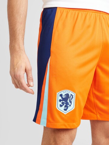 NIKE Regular Sportbroek in Oranje