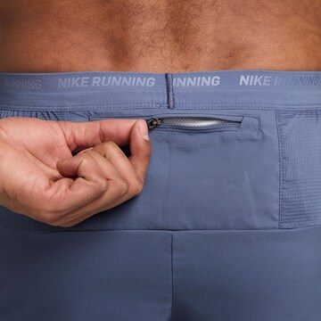 NIKE Regular Workout Pants 'Flex Stride' in Blue