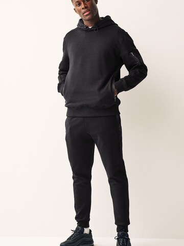 Tapered Pantaloni funzionali di Next in nero