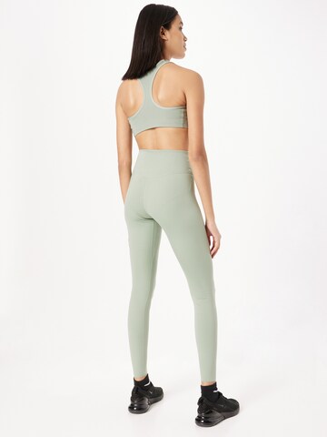 NIKE Skinny Spodnie sportowe 'One Luxe' w kolorze zielony