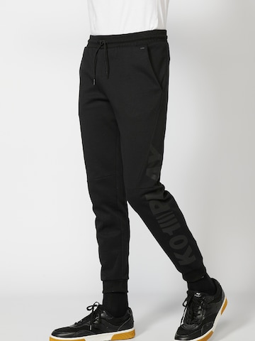 KOROSHI Regular Trousers in Black: front