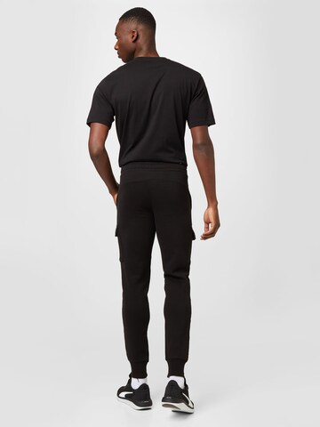 PUMA Zwężany krój Spodnie sportowe w kolorze czarny